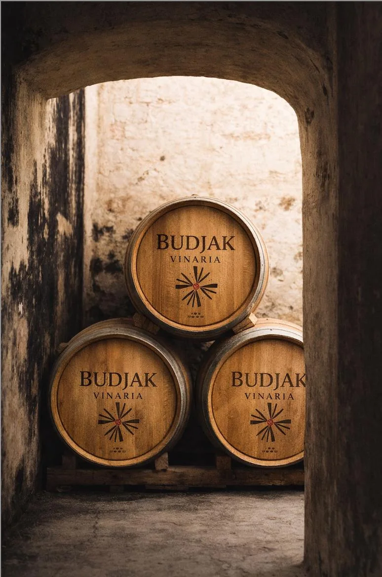 Three Budjak Vinaria barrels stacked in a stone archway