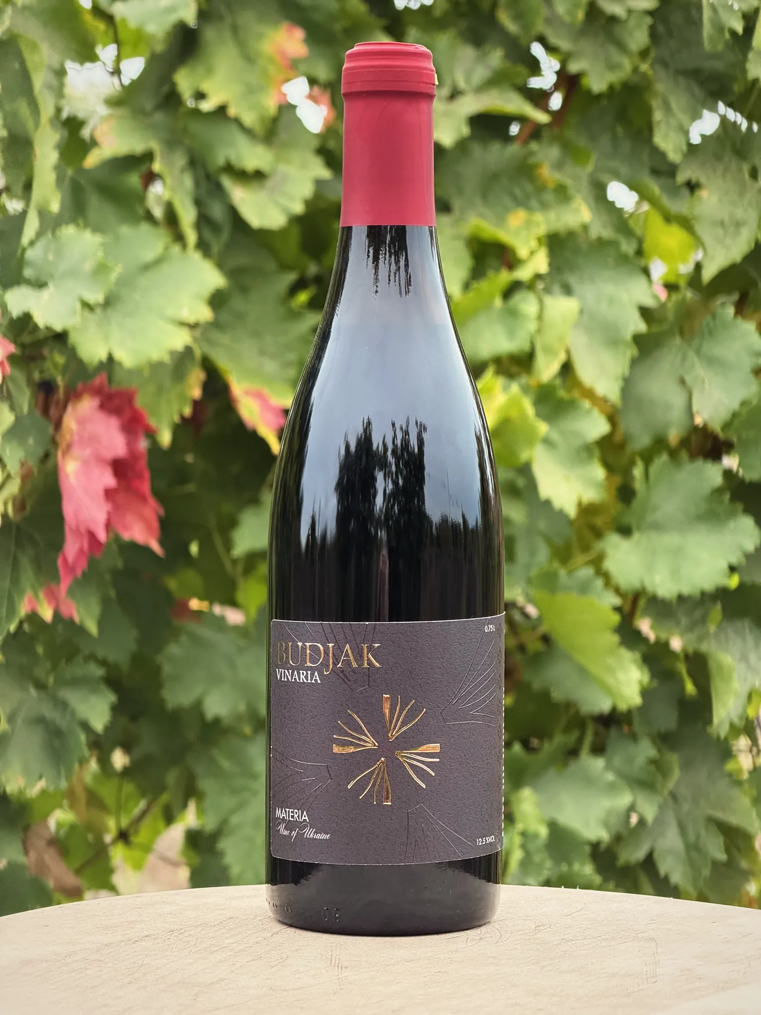 A bottle of Materia among vine leaves